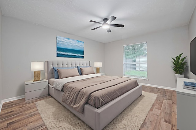 7614 Andiron Cir, Houston, TX 77041 - bedroom featuring light wood-type flooring, baseboards, and a ceiling fan
