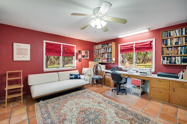 office space with light tile patterned floors, ceiling fan, and built in desk