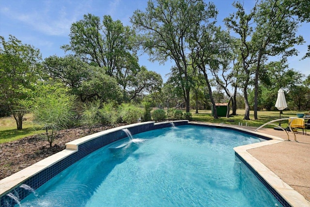 outdoor pool featuring view of wooded area