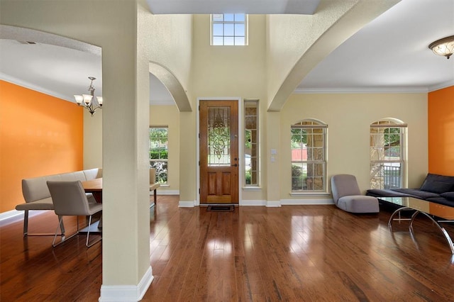 3904 Avery Woods Ln, Cedar Park, TX 78613 - foyer featuring hardwood / wood-style floors, arched walkways, a chandelier, crown molding, and baseboards
