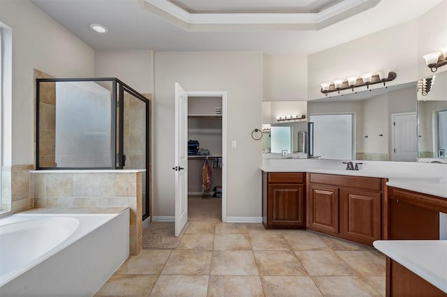 3904 Avery Woods Ln, Cedar Park, TX 78613 - bathroom featuring vanity, a shower stall, a bath, a walk in closet, and a tray ceiling