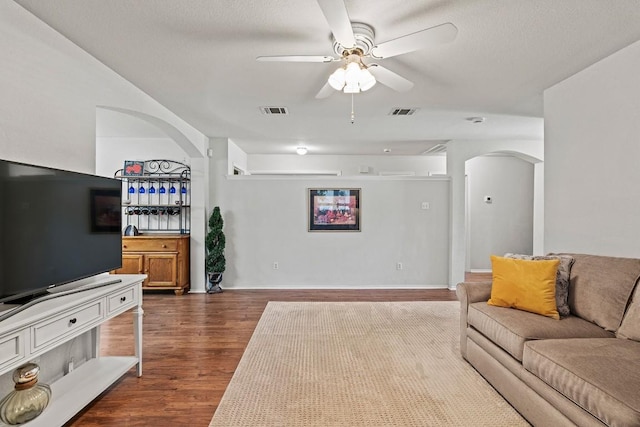 1505 Sedbury Way, Cedar Park, TX 78613 - living area with arched walkways, dark wood-style floors, and a ceiling fan