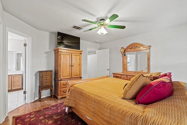 1505 Sedbury Way, Cedar Park, TX 78613 - bedroom featuring light wood finished floors, ceiling fan, and ensuite bath