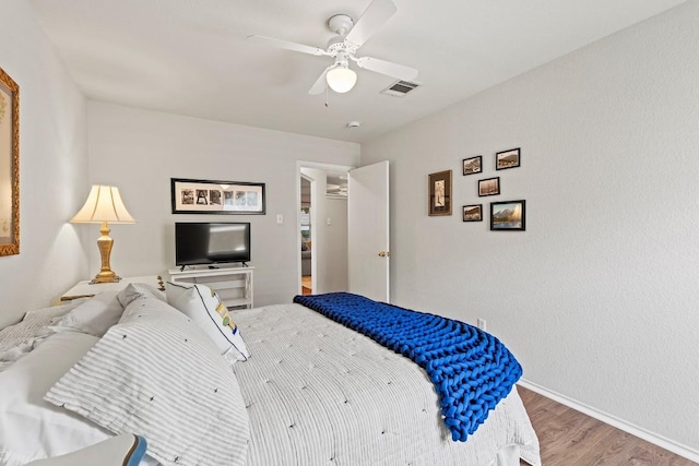 1505 Sedbury Way, Cedar Park, TX 78613 - bedroom with wood finished floors, baseboards, and a ceiling fan