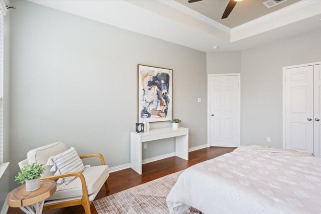 3408 Glastonbury Trl, Pflugerville, TX 78660 - bedroom with wood finished floors, crown molding, a raised ceiling, a closet, and baseboards