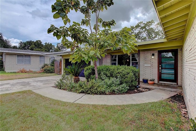 1706 Ridgemont Dr, Austin, TX 78723 - view of front of house featuring brick siding, a front yard, an attached garage, and driveway