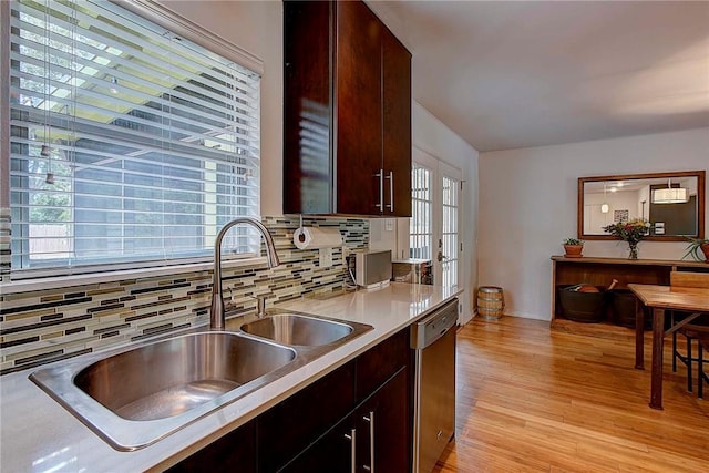 1706 Ridgemont Dr, Austin, TX 78723 - kitchen with a sink, stainless steel dishwasher, tasteful backsplash, light wood-type flooring, and light countertops