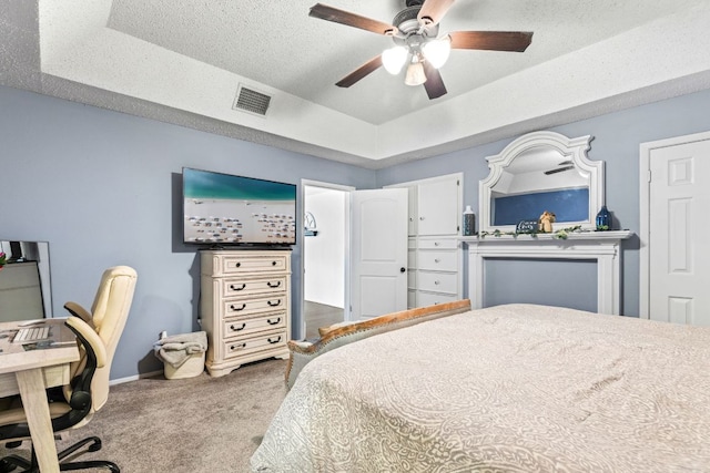 116 S Hackberry Ave, Luling, TX 78648 - carpeted bedroom with a tray ceiling, a ceiling fan, and baseboards