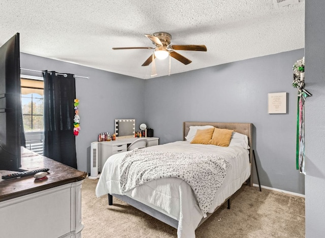 116 S Hackberry Ave, Luling, TX 78648 - bedroom with light colored carpet, a ceiling fan, and a textured ceiling