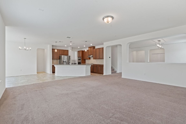 195 Azure Cv, Kyle, TX 78640 - unfurnished living room with a chandelier, light colored carpet, recessed lighting, and baseboards
