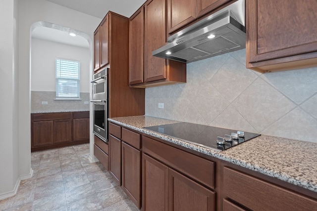 195 Azure Cv, Kyle, TX 78640 - kitchen featuring exhaust hood, black electric stovetop, tasteful backsplash, and light stone counters