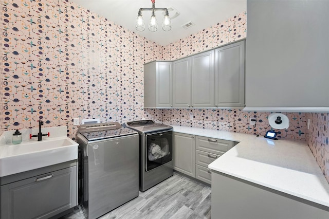 7617 Lazy River Cv, Austin, TX 78730 - laundry area featuring cabinet space, washer and dryer, and light wood-type flooring