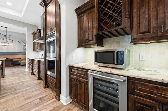 7617 Lazy River Cv, Austin, TX 78730 - kitchen featuring wine cooler, appliances with stainless steel finishes, light wood-type flooring, dark brown cabinets, and recessed lighting