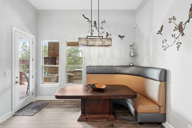 7617 Lazy River Cv, Austin, TX 78730 - dining space featuring breakfast area, wood finished floors, healthy amount of natural light, ornamental molding, and baseboards