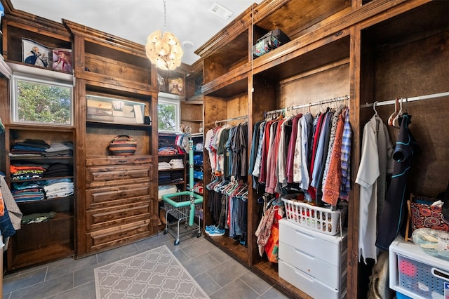 7617 Lazy River Cv, Austin, TX 78730 - spacious closet featuring a chandelier and tile patterned flooring