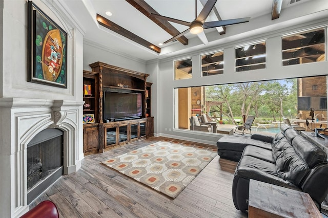 7617 Lazy River Cv, Austin, TX 78730 - living room with a ceiling fan, a fireplace, wood finished floors, recessed lighting, and beam ceiling