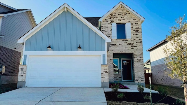 188 Grey Slate Ave, Marble Falls, TX 78654 - view of front of home featuring board and batten siding, driveway, and brick siding