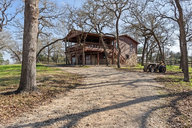 180 Bradley Ln, Rosanky, TX 78953 - view of front of house featuring a deck, dirt driveway, and stairway