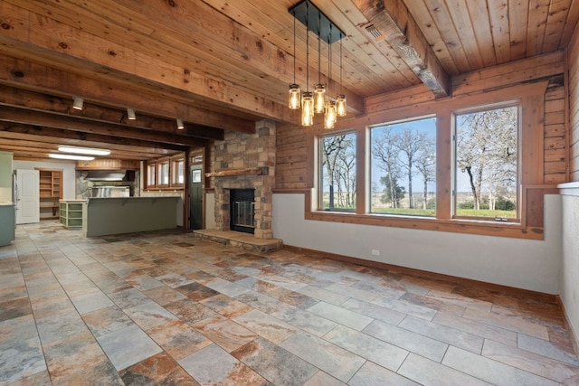 180 Bradley Ln, Rosanky, TX 78953 - unfurnished living room with a wooden ceiling with exposed beams, a fireplace, and a chandelier