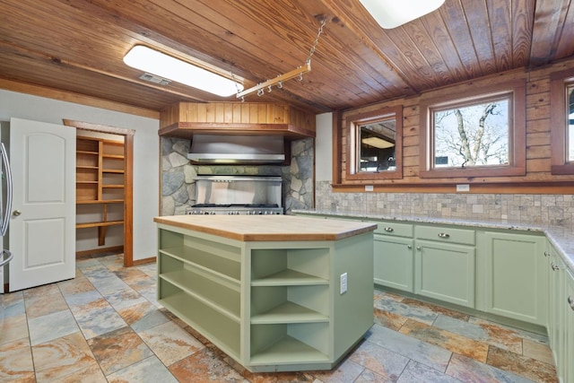 180 Bradley Ln, Rosanky, TX 78953 - kitchen featuring green cabinetry, wood ceiling, butcher block countertops, wall chimney range hood, and stone tile flooring