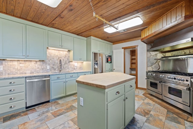 180 Bradley Ln, Rosanky, TX 78953 - kitchen with stainless steel appliances, wood ceiling, stone tile flooring, backsplash, and butcher block counters