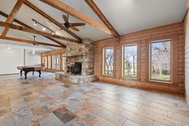 180 Bradley Ln, Rosanky, TX 78953 - unfurnished living room featuring beamed ceiling, billiards, a ceiling fan, high vaulted ceiling, and wood walls