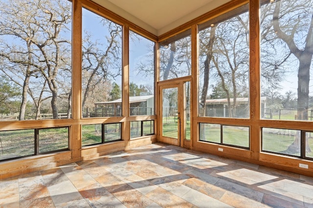 180 Bradley Ln, Rosanky, TX 78953 - unfurnished sunroom featuring stone tile flooring
