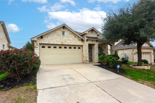 1811 Sand Creek Rd, Cedar Park, TX 78613 - view of front of property with stone siding, driveway, and a garage