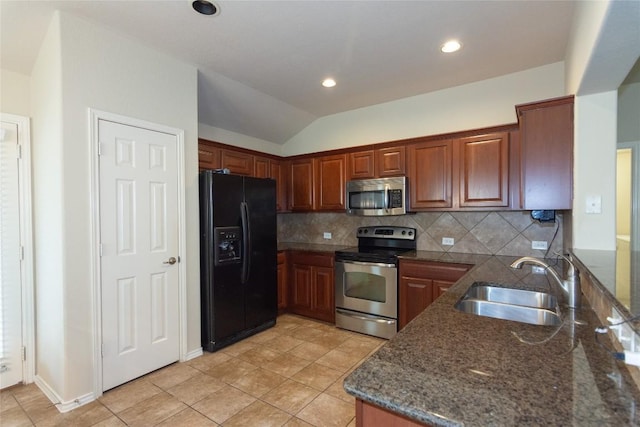 1811 Sand Creek Rd, Cedar Park, TX 78613 - kitchen with appliances with stainless steel finishes, a sink, decorative backsplash, lofted ceiling, and dark stone countertops