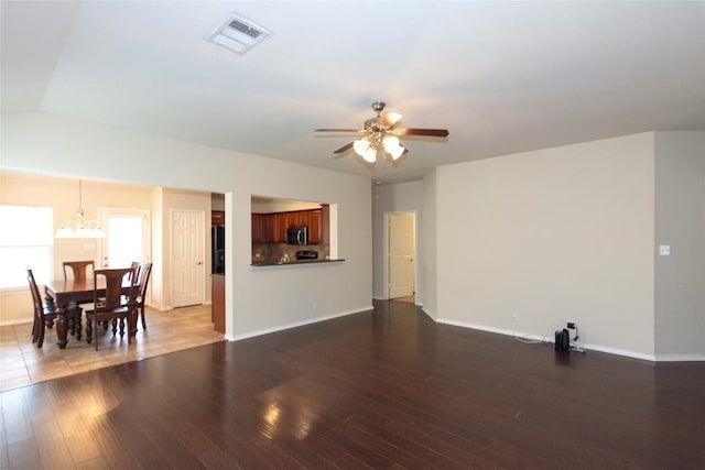 1811 Sand Creek Rd, Cedar Park, TX 78613 - living area featuring a ceiling fan, wood finished floors, baseboards, and a chandelier