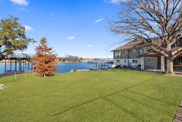 421 Yucca Dr, Kingsland, TX 78639 - view of green lawn with a water view, a dock, and boat lift