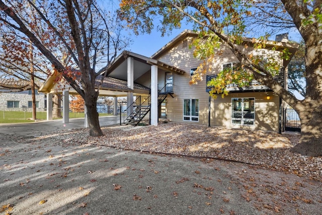 421 Yucca Dr, Kingsland, TX 78639 - rear view of house with stairs and a carport