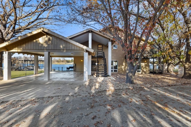 421 Yucca Dr, Kingsland, TX 78639 - view of front of house featuring a carport, stairs, driveway, and a water view