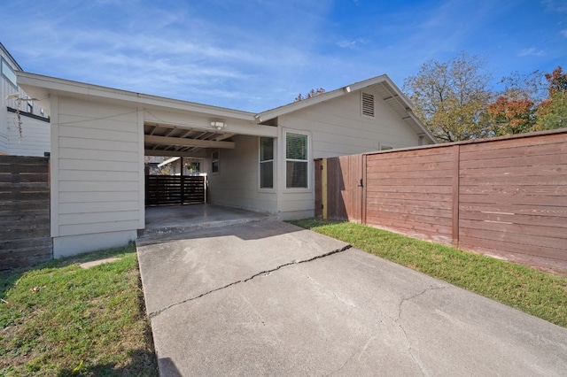 4701 Sylvandale Dr Unit 1, Austin, TX 78745 - rear view of property featuring driveway and an attached carport