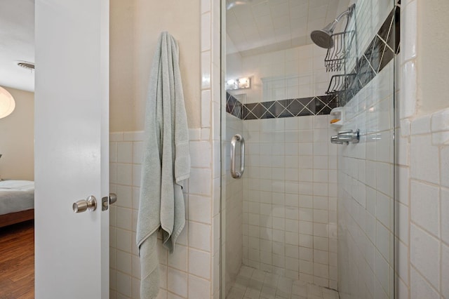 4701 Sylvandale Dr Unit 1, Austin, TX 78745 - full bathroom featuring a stall shower, connected bathroom, and wood finished floors