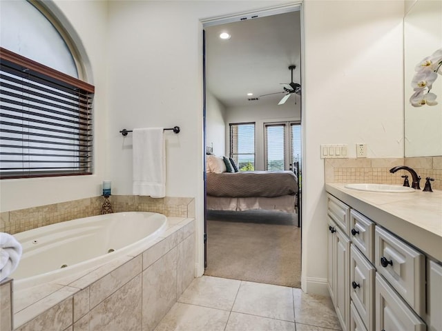 17545 E Reed Parks Rd Unit 5, Jonestown, TX 78645 - ensuite bathroom featuring ceiling fan, a whirlpool tub, vanity, tile patterned flooring, and backsplash