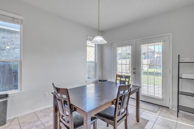 1062 Bowline Dr, Georgetown, TX 78633 - dining room with french doors, light tile patterned flooring, and baseboards