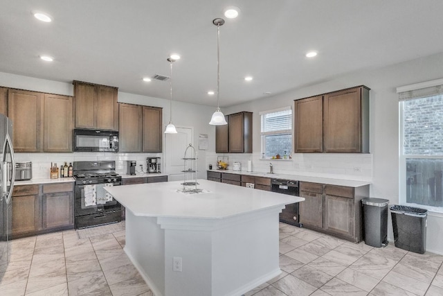 1062 Bowline Dr, Georgetown, TX 78633 - kitchen featuring black appliances, light marble finish floors, a kitchen island, tasteful backsplash, and recessed lighting