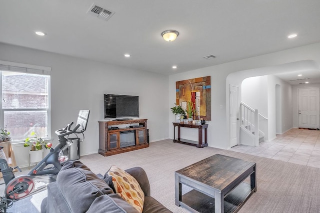 1062 Bowline Dr, Georgetown, TX 78633 - living room with arched walkways, stairs, recessed lighting, and baseboards