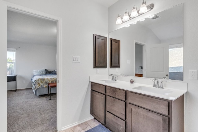 1062 Bowline Dr, Georgetown, TX 78633 - full bathroom with ensuite bath, double vanity, baseboards, and vaulted ceiling