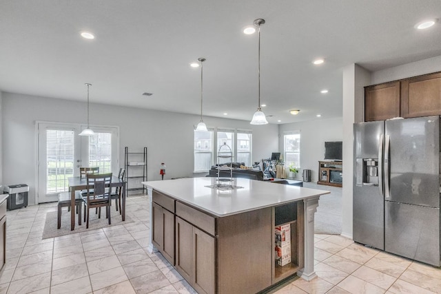 1062 Bowline Dr, Georgetown, TX 78633 - kitchen featuring stainless steel fridge, light countertops, recessed lighting, plenty of natural light, and open floor plan