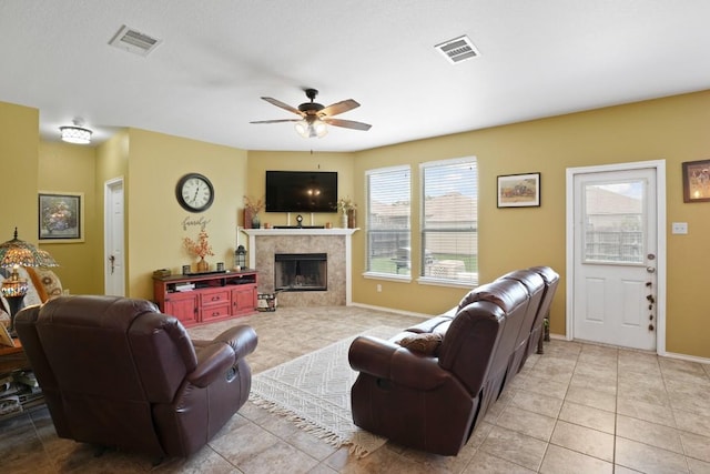 108 Marcheeta Way, Leander, TX 78641 - living room featuring ceiling fan, light tile patterned flooring, and a tiled fireplace