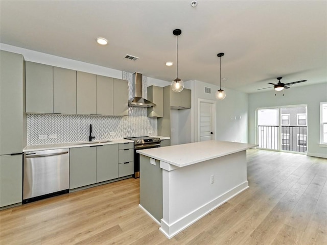 2500 Longview St Unit 518, Austin, TX 78705 - kitchen with stainless steel appliances, wall chimney range hood, gray cabinetry, a sink, and tasteful backsplash