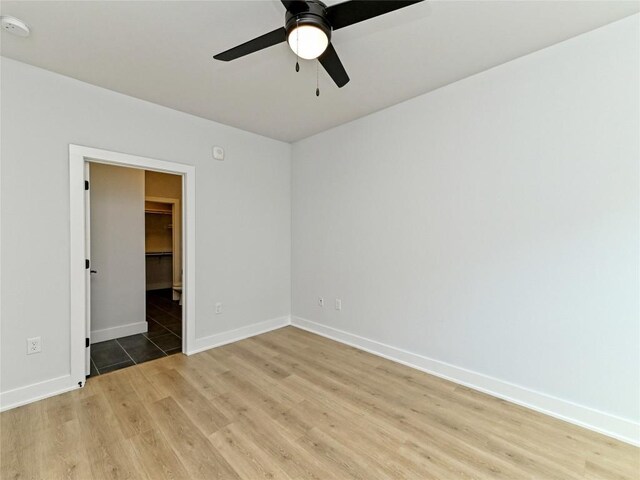 2500 Longview St Unit 518, Austin, TX 78705 - unfurnished room with light wood-style flooring, ceiling fan, baseboards, and a smoke detector