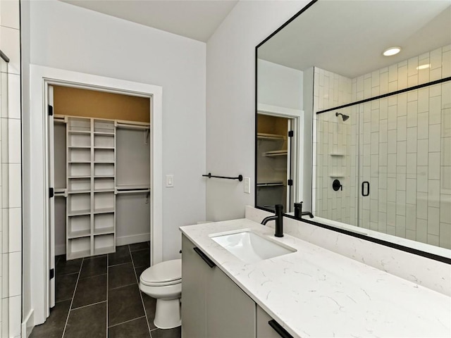 2500 Longview St Unit 518, Austin, TX 78705 - bathroom with a walk in closet, tile patterned floors, and vanity