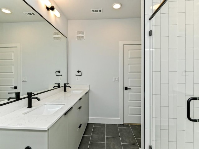 2500 Longview St Unit 518, Austin, TX 78705 - bathroom with tile patterned flooring, double vanity, a shower stall, recessed lighting, and baseboards