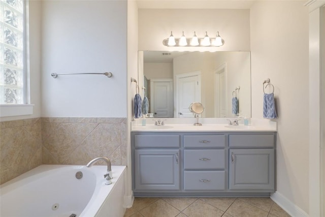 6305 Carrington Dr, Austin, TX 78749 - bathroom featuring double vanity, a jetted tub, and tile patterned flooring