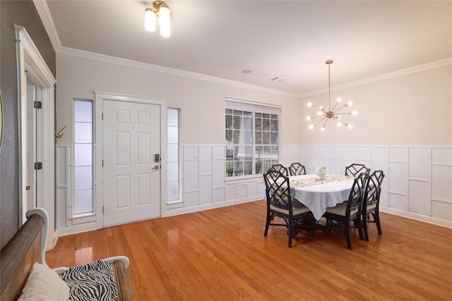 6305 Carrington Dr, Austin, TX 78749 - dining area with wood finished floors, ornamental molding, a chandelier, and wainscoting