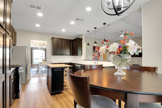 606 Indian Run Dr, Pflugerville, TX 78660 - dining area featuring light wood-type flooring, a chandelier, recessed lighting, and a ceiling fan