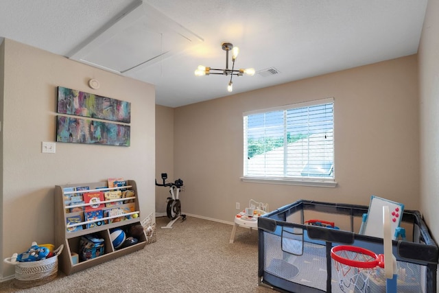 606 Indian Run Dr, Pflugerville, TX 78660 - rec room featuring attic access, carpet floors, baseboards, and a chandelier